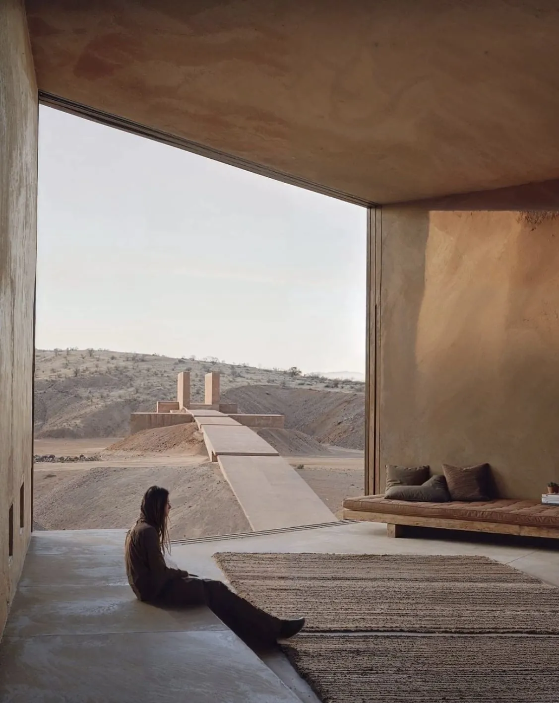 A guest at the edge of a terrace, looking out over the valley